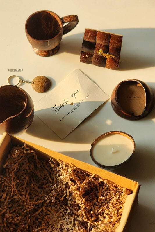 Collection of decorative items including a wooden cup, candle, and card on a textured surface.