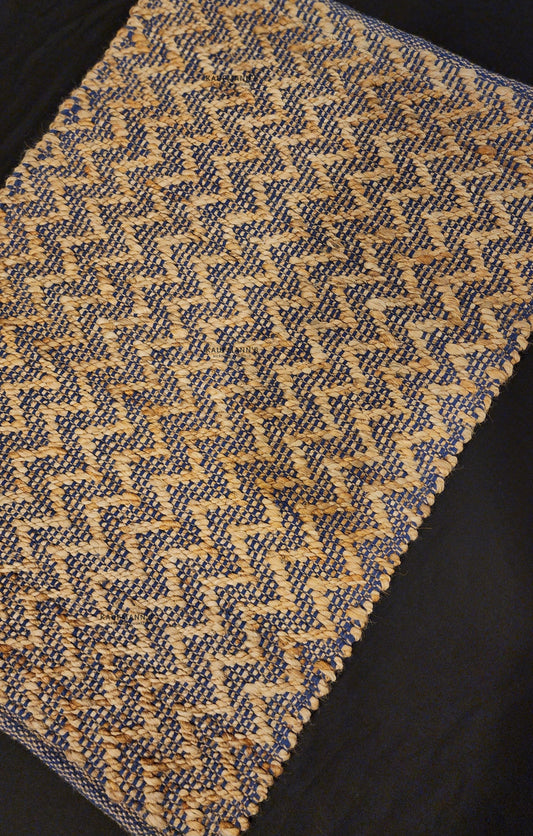 A jute rug with a geometric pattern beige colors, showcasing a textured design. featuring a combination of blue and 