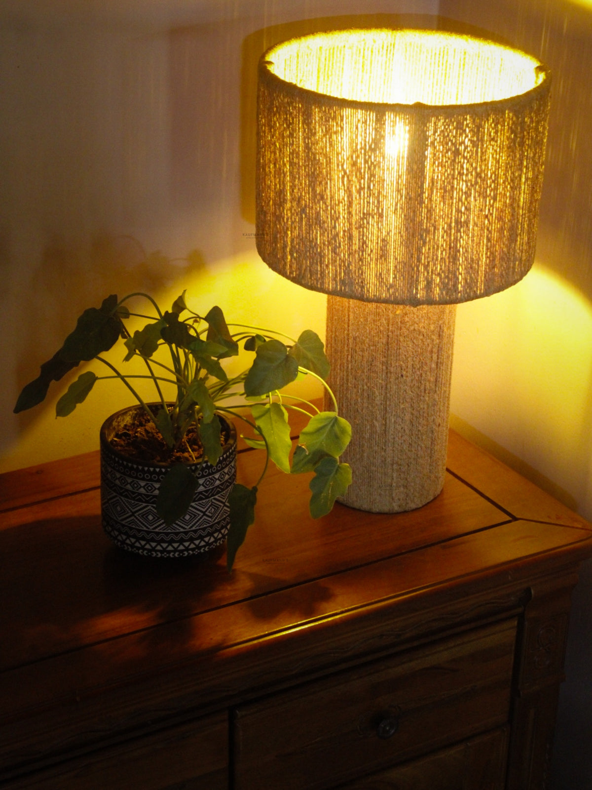 Jute Table Lampshades with textured shade and plant on a wooden surface