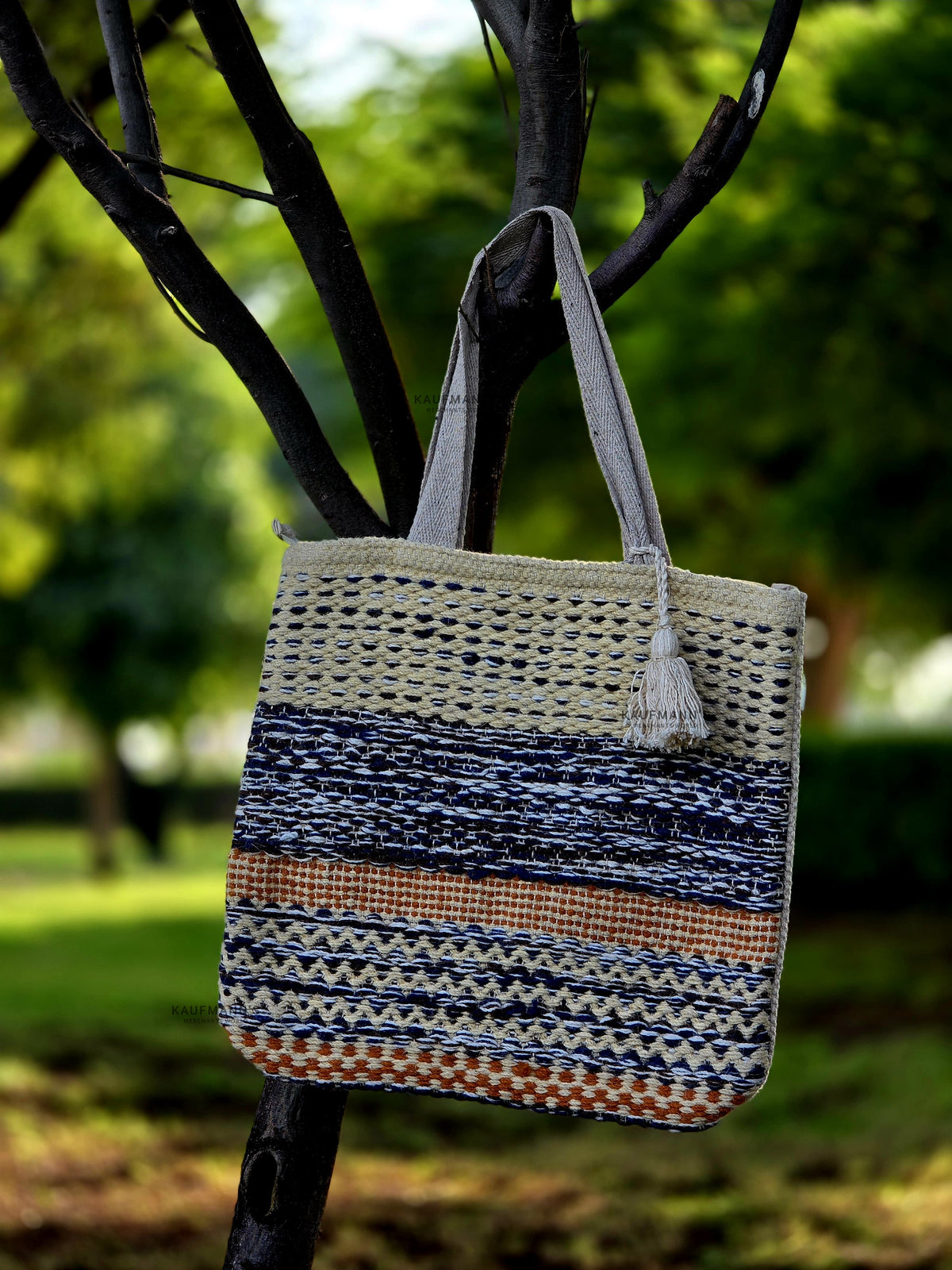 Jute Tote Bag Hanged in a branch of tree n a green park background
