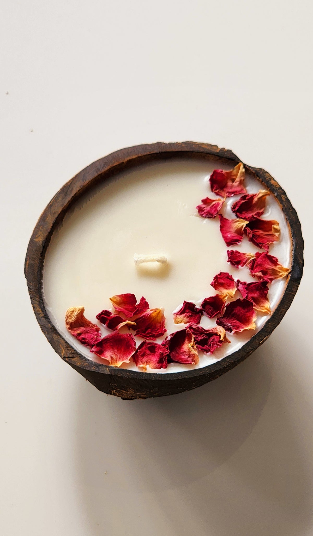 Coconut shell candle in Rose Petal Flavour.
